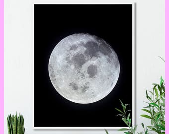 May include: A black and white photograph of a full moon against a dark sky.
