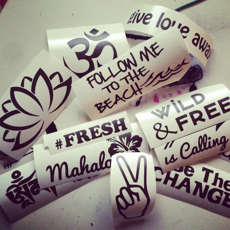 May include: Assortment of stickers with various designs and phrases, including "Follow Me to the Beach", "Wild & Free", "#Fresh", "Mahalo", "Om", and a peace sign.