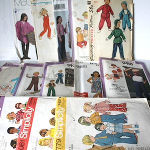 May include: A collection of vintage sewing patterns for children's clothing. The patterns are from Simplicity and include designs for toddlers and children. The patterns feature a variety of styles, including dresses, shirts, trousers, and jackets. The patterns are in various colours, including red, blue, yellow, and green.