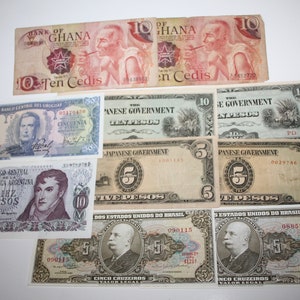 May include: A collection of vintage banknotes from various countries, including Ghana, Uruguay, Argentina, Japan, and Brazil. The bills display portraits, text, and denominations such as "Ten Cedis" and "Five Pesos". The banknotes are in various colors.