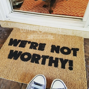 Funny doormat, we&#39;re not worthy!  The best place for a guest to wipe their feet!