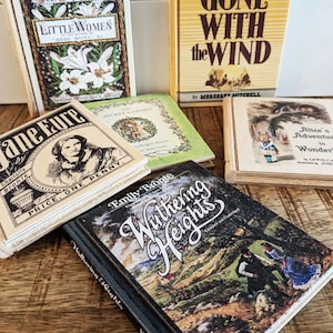 An arrangement of 6 wooden book coasters sits on a distressed table.