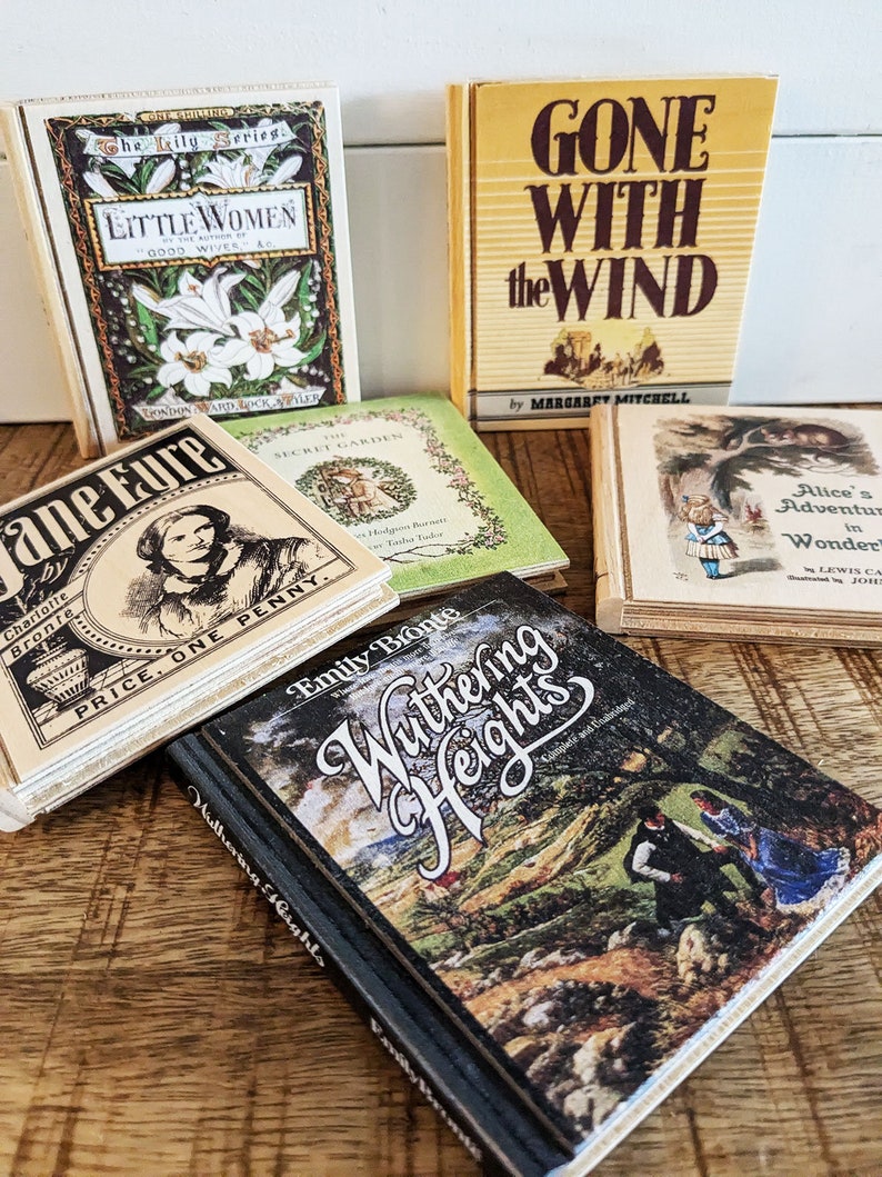 An arrangement of 6 wooden book coasters sits on a distressed table.