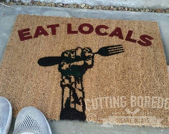 Eat locals, a funny zombie coir doormat, The perfect Halloween decoration for the houses of the undead!