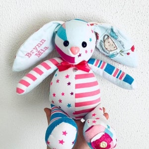 May include: A handmade patchwork bunny toy with pink and blue stripes, white stars, and a pink bow. The bunny's ears are white with the names "Brynn Mia" embroidered on one ear.