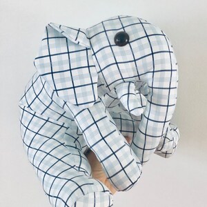 May include: A blue and white plaid stuffed elephant toy with a black button eye.