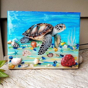 May include: A painting of a green sea turtle swimming in a blue ocean with seashells and coral. The turtle is painted in a realistic style with detailed scales and a bright green shell.