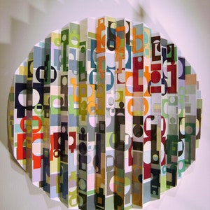 SOLD     a paper,wood wall sculpture,titled &quot;ball of confusion&quot;