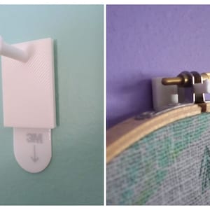 May include: Two white plastic hooks for hanging items on a wall. The hook on the left has a 3M adhesive strip and the hook on the right has a screw and a metal clamp.