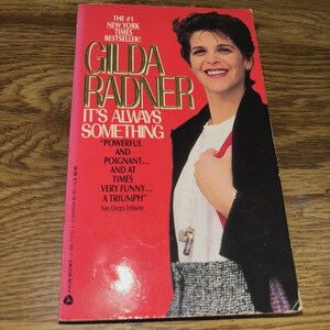 May include: A paperback book titled "It's Always Something" by Gilda Radner. The cover is red with the author's name in gold lettering and a photo of Radner. The book is a New York Times bestseller.