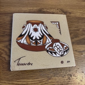 May include: A set of three ceramic mugs with a speckled, matte finish. The mugs are in shades of cream, light gray, and dark gray. Each mug has a simple, minimalist design and a rounded handle.