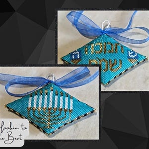 May include: Two beaded Hanukkah ornaments. One is turquoise with gold Hebrew text and a blue ribbon. The other is turquoise with a gold menorah design and white candles. The ornaments are diamond-shaped.