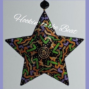 May include: A black, green, gold, and purple beaded star ornament with a geometric pattern. The ornament is hanging from a black bead. The text "Hookin' to the Beat" is written in white on a black background.
