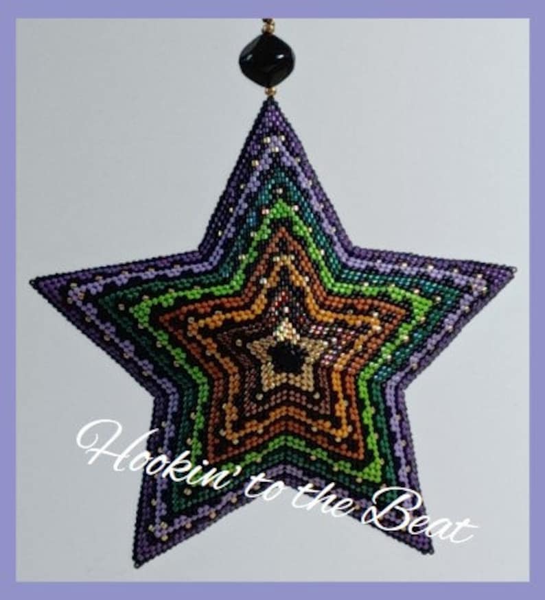 May include: A multi-colored beaded star ornament with a black bead at the top. The star is made of a variety of colors, including purple, green, brown, and black. The text "Hookin' to the Beat" is written in white on a black background below the star.