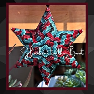 May include: A red, black, and turquoise beaded star ornament with the text "Hookin' to the Beat" in white cursive lettering.