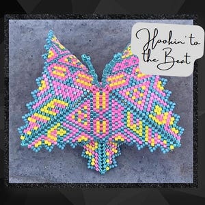 May include: A colorful butterfly-shaped beaded design in pink, yellow, and blue, with the text "Hookin' to the Beat" in white on a gray background.