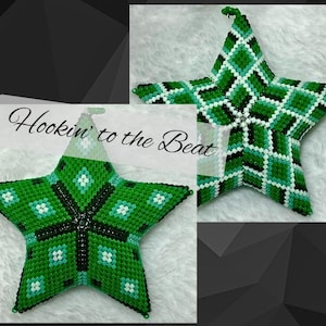 May include: A green star-shaped ornament with a beaded design. The star features a pattern of green, white, and black beads. The text "Hookin' to the Beat" is visible in the image. The ornament is likely handmade and suitable for holiday decor.