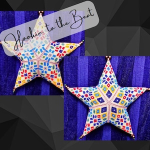May include: Two colorful star-shaped beaded ornaments with a geometric pattern. The stars are white with red, blue, yellow, and green beads. The background is a purple striped fabric. The text "Hookin' to the Beat" is written in white on a transparent background.