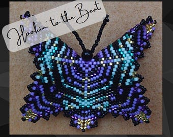 May include: A beaded butterfly with black, purple, white, gold, and teal accents. The butterfly is hanging from a black cord. The text "Hookin' to the Beat" is written in white on a black background.