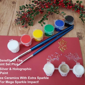 6 different coloured acrylic paints in a strip & 3 different glitters with a pair of detail paintbrushes for adults