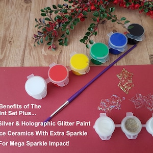6 different coloured acrylic paints in a strip & 3 different glitters with a colourful handled childrens paintbrush