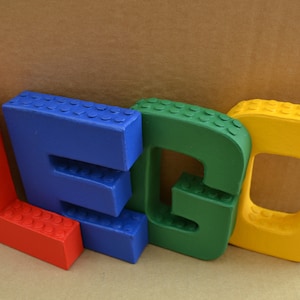 Hand painted papier mache lego letters in red, blue, green & yellow