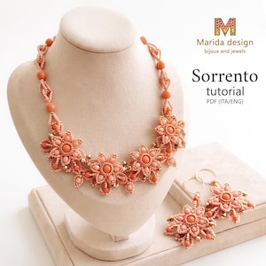 May include: A beaded necklace and matching earrings set in shades of peach and coral. The jewelry features intricate floral motifs crafted from small seed beads and larger round beads. Text reads: Marida design bijoux and jewels Sorrento tutorial PDF (ITA/ENG).