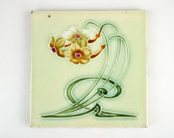 Antique 1900s Henry Richards Art Nouveau narcissus with cream background pottery tile.