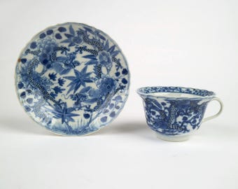 Antique 19th century Chinese blue and white dragon porcelain cup and saucer. Kangxi marks.