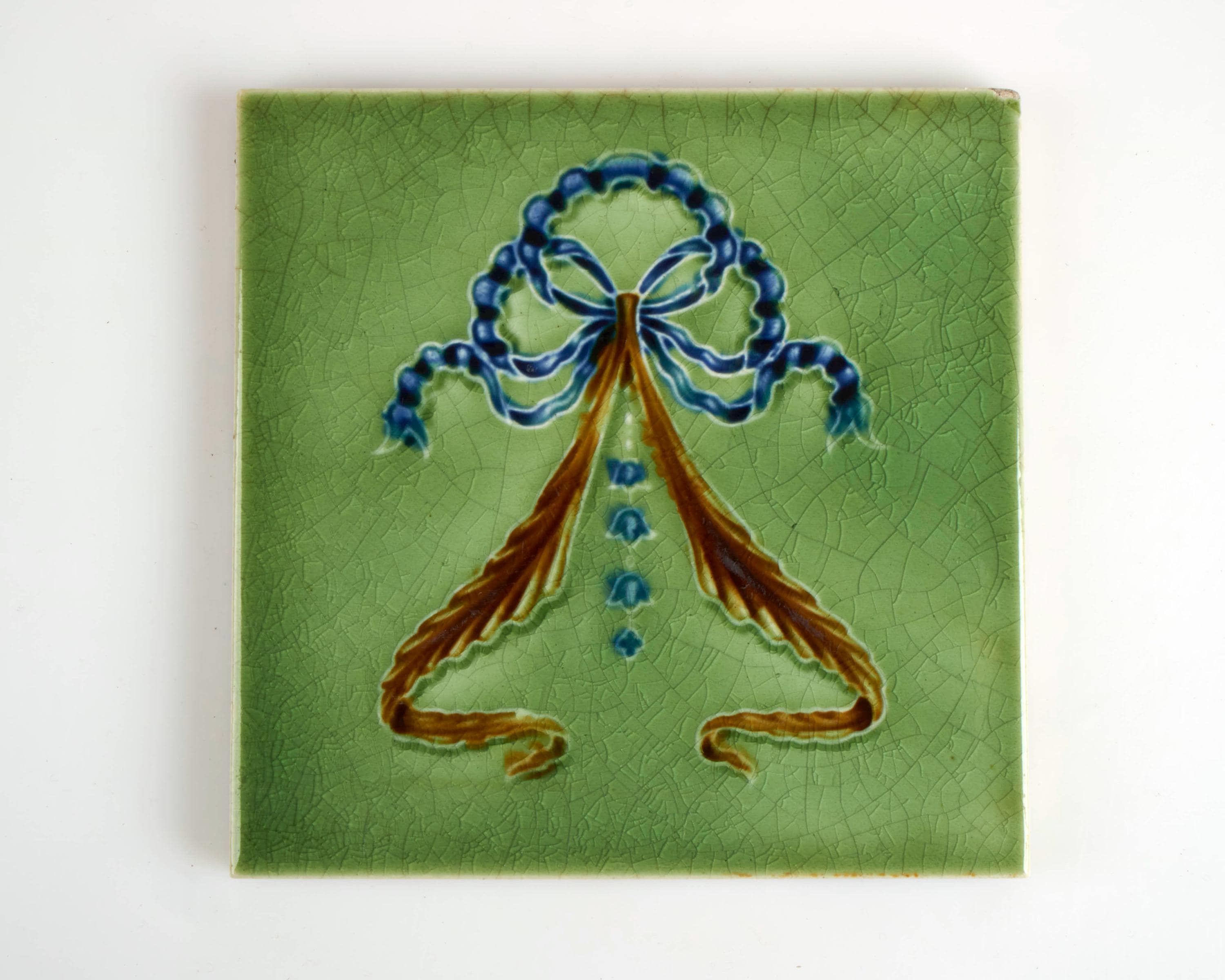 Antique 1900s Thomas Boote & Son Art Nouveau blue ribbon pottery tile.