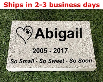 May include: A white rectangular stone memorial with black text that reads "Abigail 2005-2017 So Small - So Sweet - So Soon". A black paw print is inside a heart.