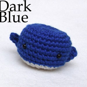 May include: Dark blue crocheted whale with white belly and black eyes.