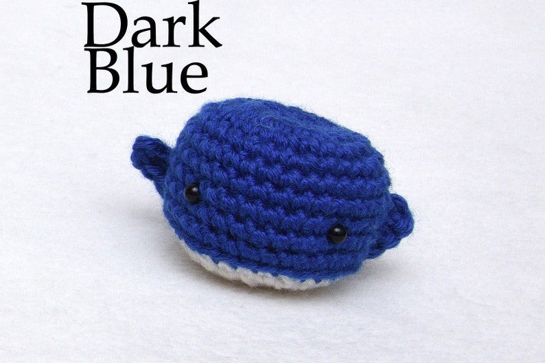 May include: Dark blue crocheted whale with white belly and black eyes.