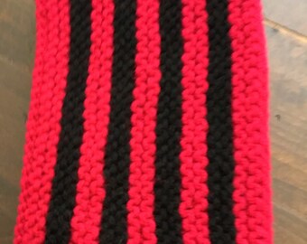 Hand knitted scarf in red and black with crocheted ends.