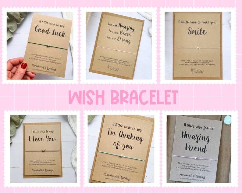 May include: A collection of wish bracelets on kraft paper cards with various messages like "Good Luck" and "I Love You." Each card has a small charm and a string bracelet. The word "WISH BRACELET" is displayed in pink.