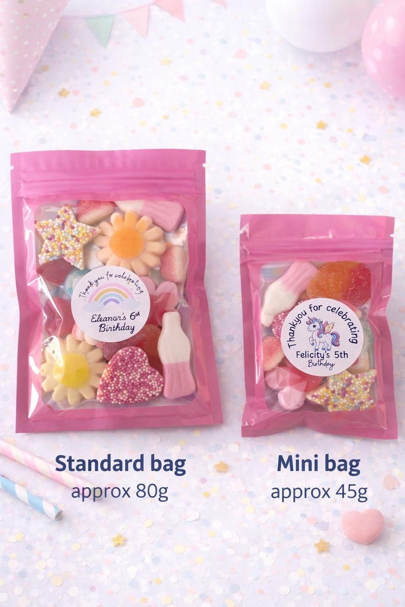 K&ouml;nnte beinhalten: Zwei wiederverschlie&szlig;bare rosa Plastikt&uuml;ten gef&uuml;llt mit bunten Fruchtgummis. Die gr&ouml;&szlig;ere T&uuml;te ist mit 'Thank you for celebrating Eleanor's 6th Birthday' beschriftet, die kleinere mit 'Thank you for celebrating Felicity's 5th Birthday'.