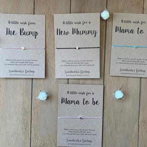 May include: Four greeting cards with bracelets, each with a different message: "A little wish from The Bump", "A little wish for a New Mummy", and "A little wish for a Mama to be". Each card has a bracelet with a small charm.