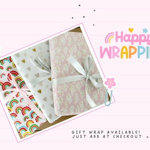 May include: Three wrapped gifts with decorative paper and ribbons. The wrapping paper features patterns of rainbows, hearts, and floral designs. The image includes the text "Happy WRAPPING" in colorful letters.