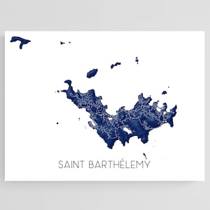May include: A white rectangular print featuring a detailed navy blue map of Saint Barthélemy. The island's outline is filled with intricate road details. The words "SAINT BARTHÉLEMY" are printed in a simple, dark font at the bottom of the print.
