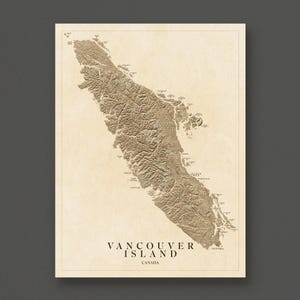 May include: A detailed, sepia-toned map of Vancouver Island, Canada, with topographical features and city names. The text "Vancouver Island" and "Canada" are printed at the bottom. The map is framed with a cream-colored border.