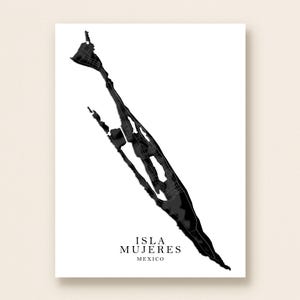 May include: A black and white map print of Isla Mujeres, Mexico. The map features a detailed outline of the island with a minimalist design. The text "ISLA MUJERES MEXICO" is printed at the bottom of the print.