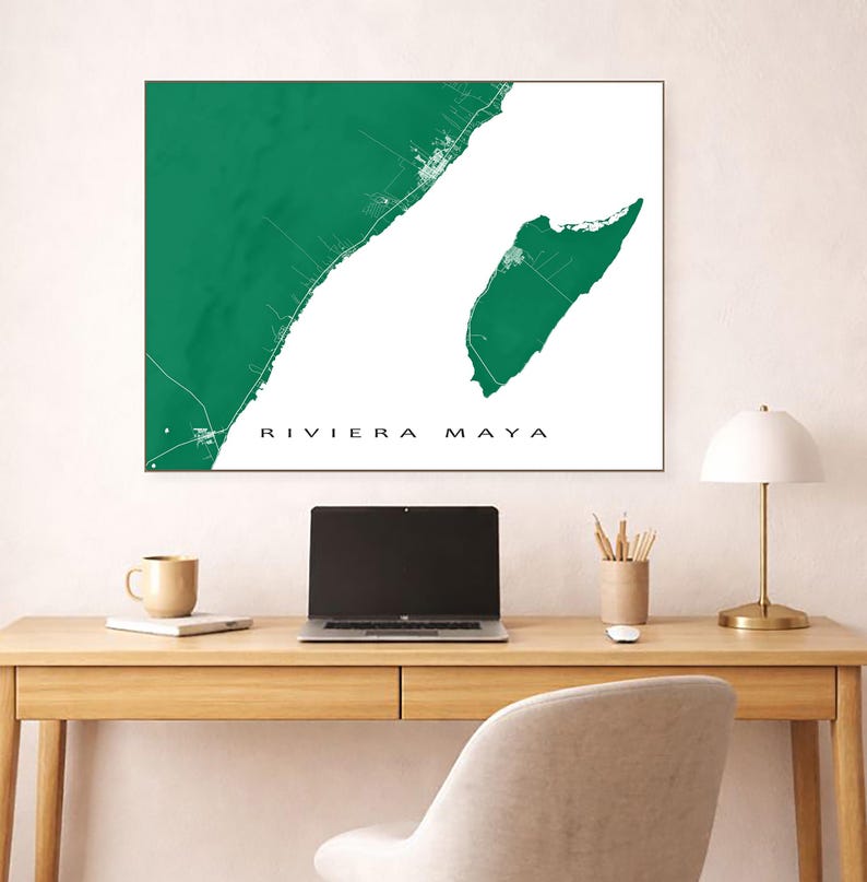 May include: A green and white Riviera Maya map print. The map features a detailed outline of the coastline and surrounding areas. The text "RIVIERA MAYA" is printed in a clean, sans-serif font. The print is displayed on a wall above a wooden desk.