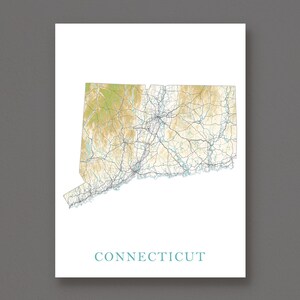 May include: A framed print showing a detailed topographical map of Connecticut. The map uses shades of tan, green, and blue to depict the state's terrain and waterways. The word "CONNECTICUT" is printed in teal at the bottom.