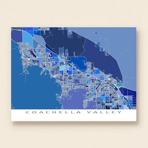 May include: A map of Coachella Valley in shades of blue, with a white border at the bottom. The text "COACHELLA VALLEY" is printed in black, centered at the bottom of the image. The map shows the area's roads and buildings.
