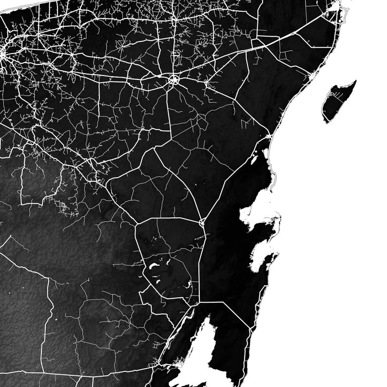 May include: A black and white map print featuring a detailed network of roads and highways. The map shows a coastal region with a complex road system, and a white background. The image is a high-contrast, graphic representation of an area.