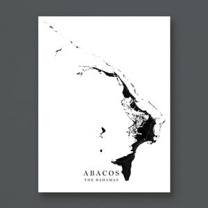 May include: A monochrome map print of Abacos, The Bahamas. The islands are depicted in black against a white backdrop. The text "ABACOS" and "THE BAHAMAS" is printed in black at the bottom of the print.