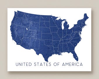 May include: A blue and white print of the United States of America. The map shows the country's states and geographical features. The words "UNITED STATES OF AMERICA" are printed in a dark blue font at the bottom of the print.