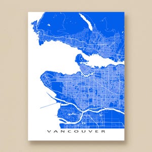 May include: A blue and white map of Vancouver, Canada, with the city's streets and waterways detailed. The word "VANCOUVER" is printed in white at the bottom of the map. The map is displayed on a white background.