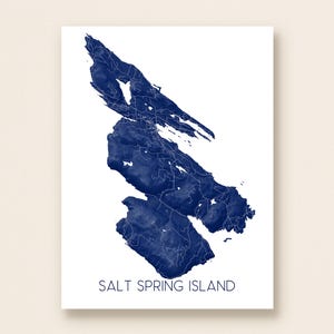 May include: A navy blue watercolor map of Salt Spring Island on a white background. The map shows the island's outline and internal roads. The text "SALT SPRING ISLAND" is printed in navy blue at the bottom of the image.