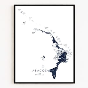 May include: A framed print showing a detailed map of Abacos, The Bahamas. The map is navy blue on a white background, with place names and geographical features labelled. The print is in a black frame.
